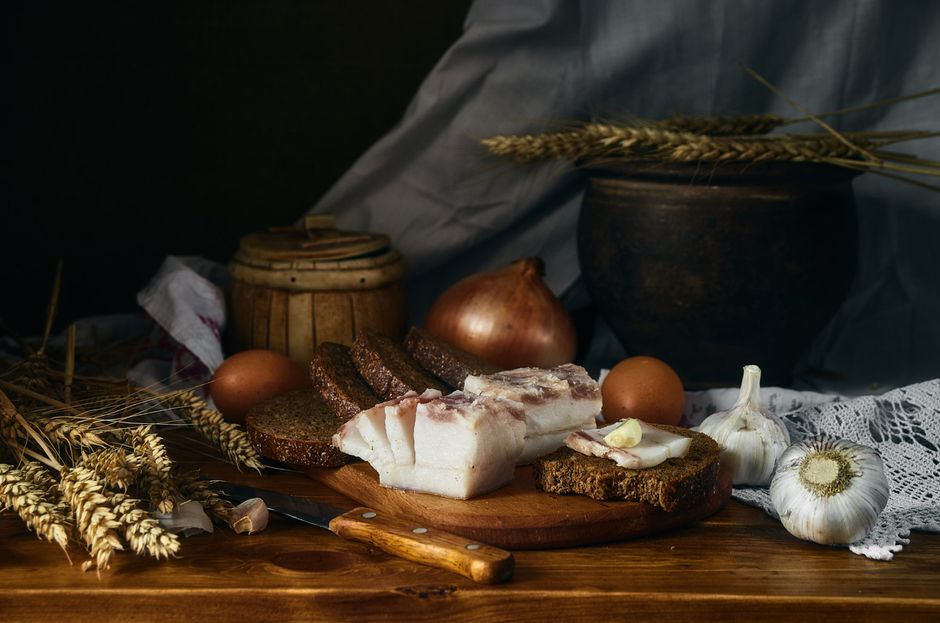 Polish zurek soup ingredients sausage egg garlic on wooden table