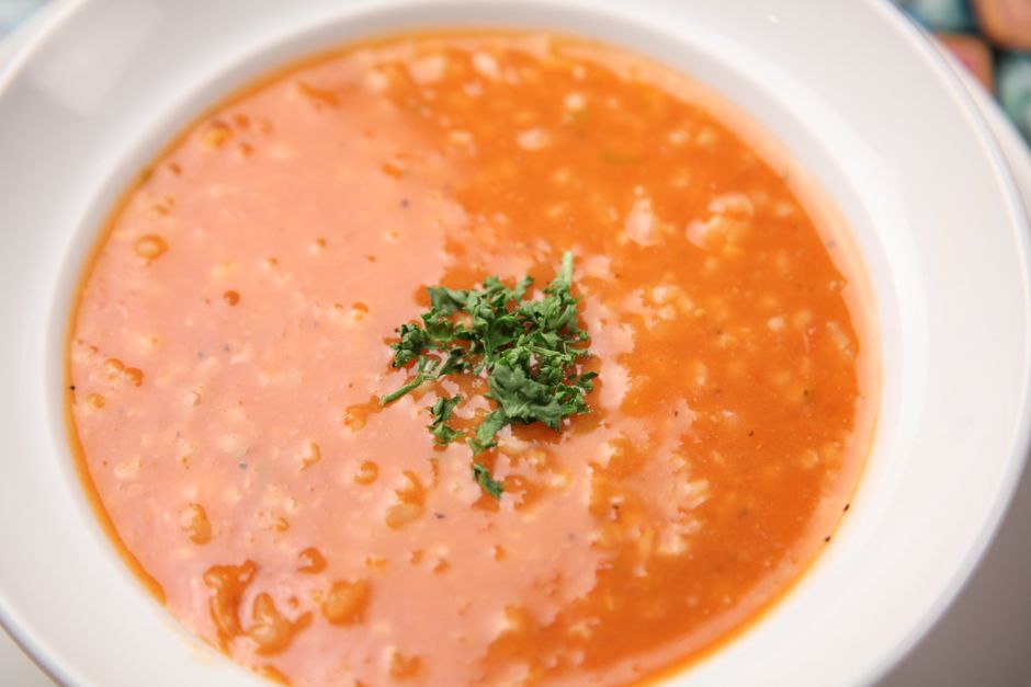 creamy tomato rice soup bowl wooden table