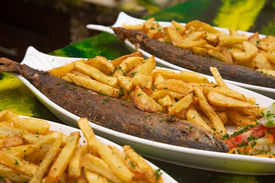 golden fried fish patties on plate with potatoes