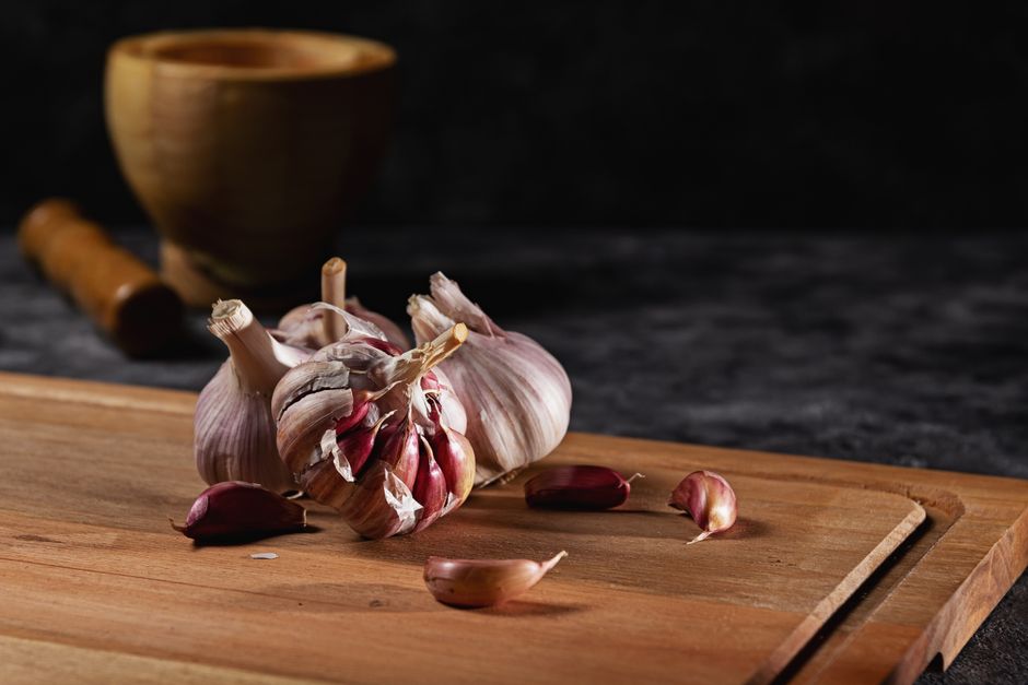 fresh green beans garlic cloves on wooden board