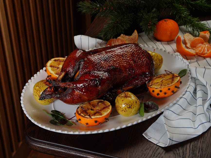 roasted golden duck with apples on serving platter