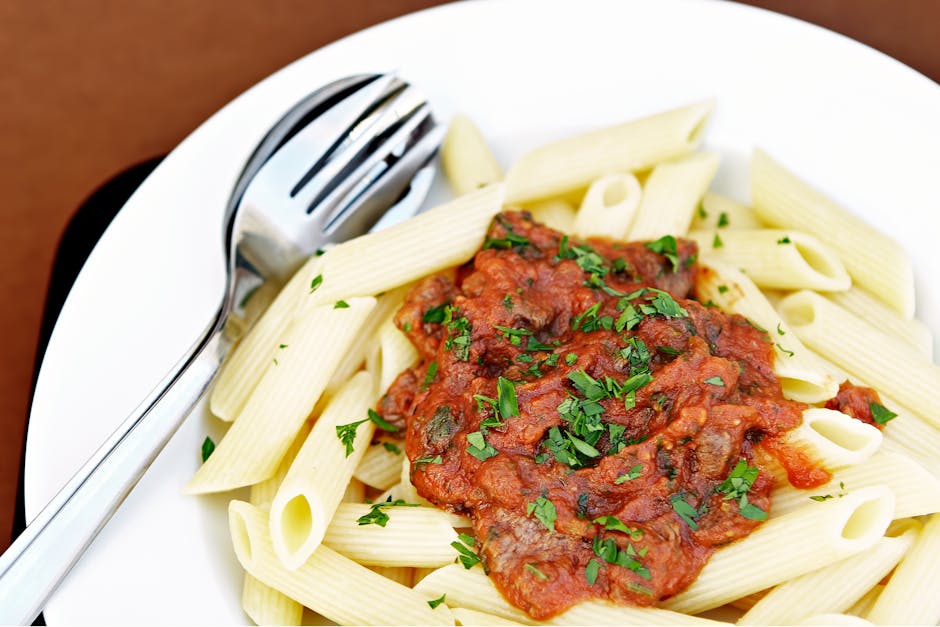ground beef cooking in pan pasta sauce