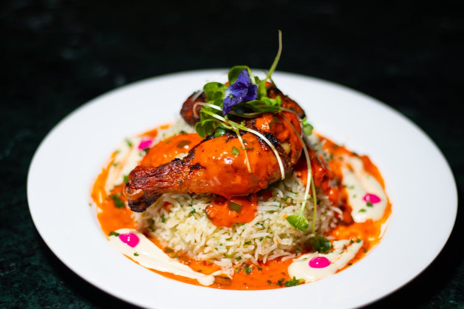 creamy chicken dish finished plated with rice herbs