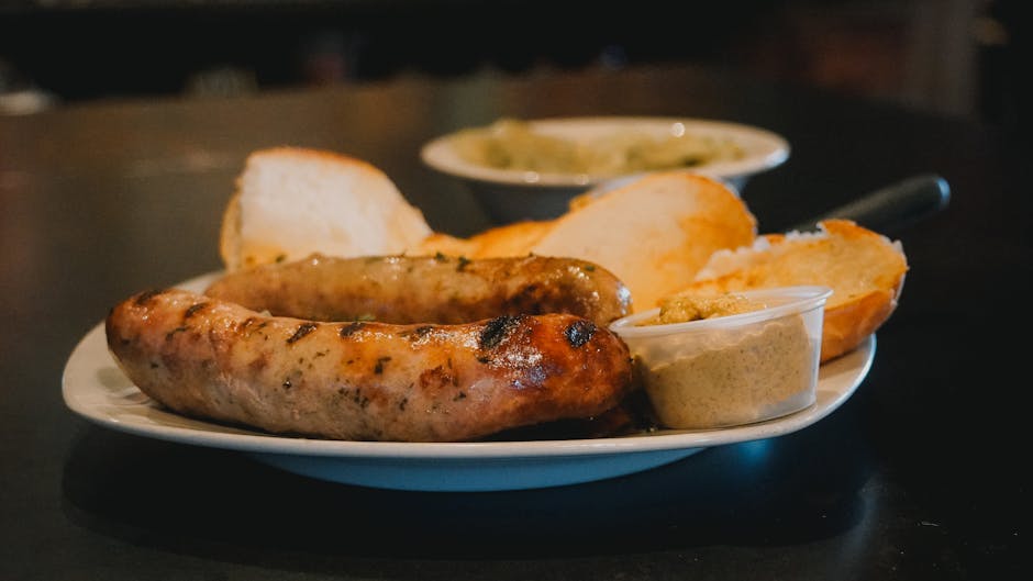 white sausage with onions and mustard on plate