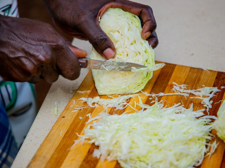 shredded white cabbage on cutting board