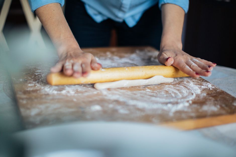 rolling potato dough into logs on floured board