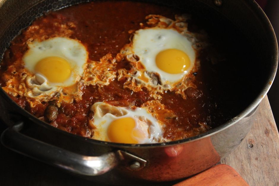 shakshuka cooking in pan with lid