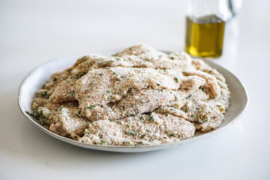 chicken cutlets being formed by hands with ingredients