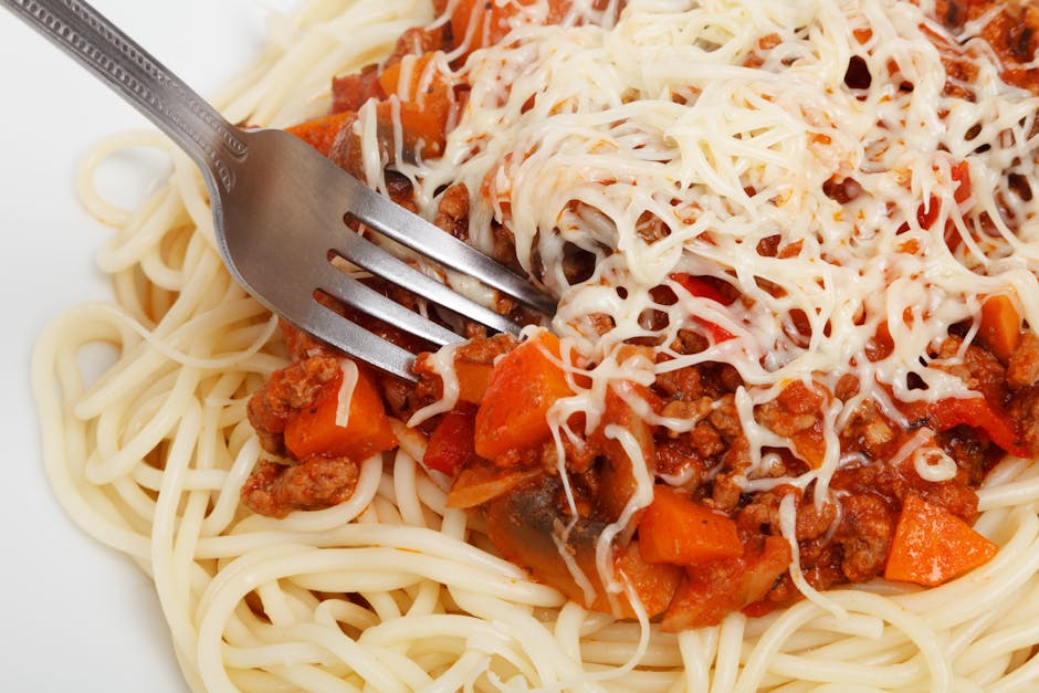 spaghetti bolognese served plate parmesan cheese