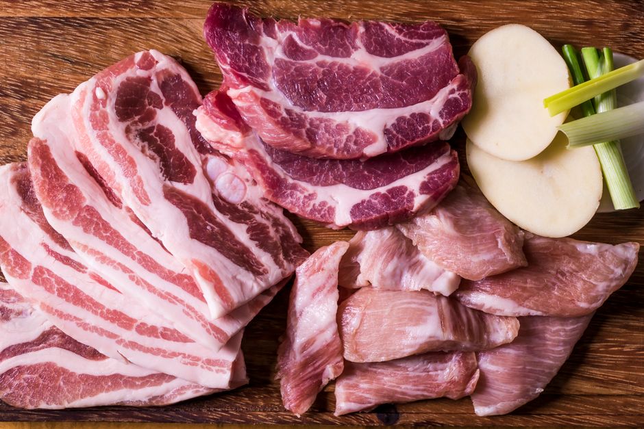 raw pork shoulder and beef chuck on cutting board