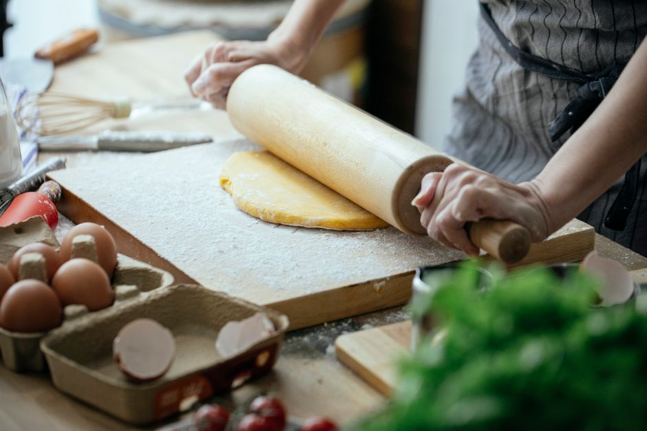 rolling pancakes with filling on cutting board