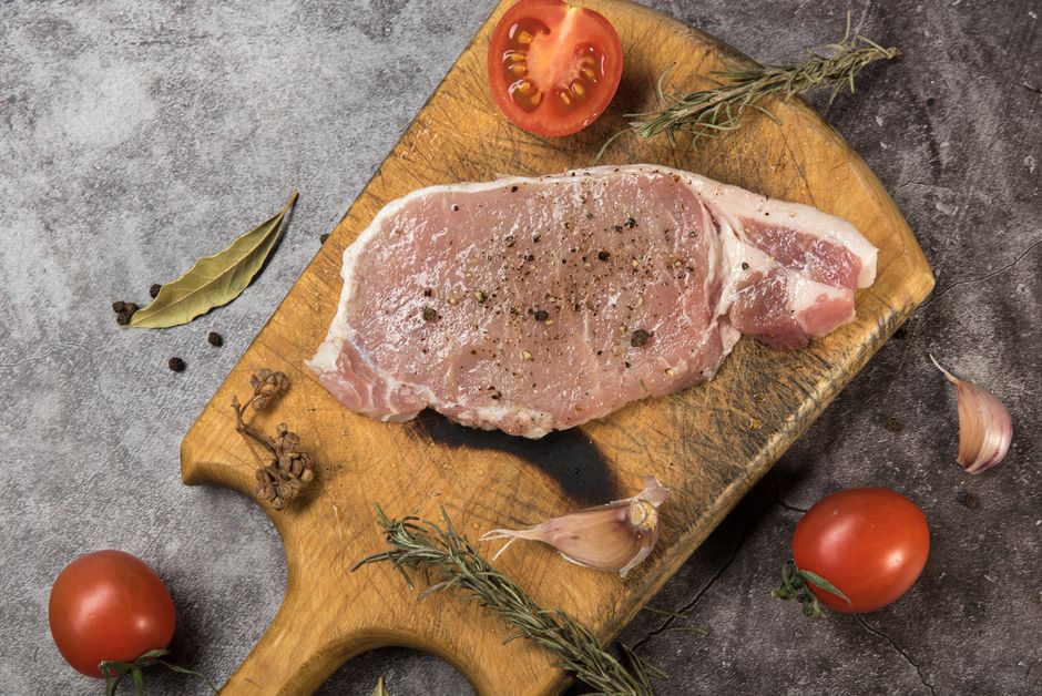 sliced pork loin cutlets on cutting board