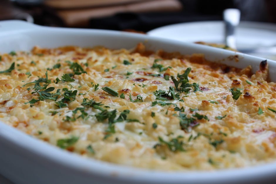 golden baked pasta casserole with cheese top in oven dish