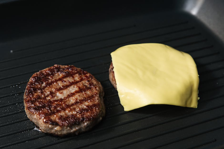 burger patty cooking on grill pan