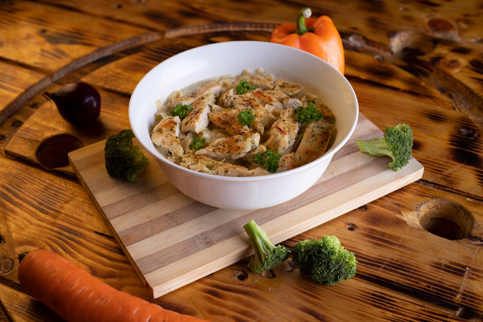 cooked chicken with carrots and peas in creamy sauce